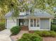 Charming home features gray siding, white trim, and a brick walkway leading to the front door at 10 Marchmont Ct, Durham, NC 27705