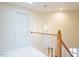 Hallway features a pendant light and wooden handrail with white spindles at 10 Marchmont Ct, Durham, NC 27705