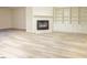 Open concept living room featuring luxury vinyl plank flooring, a fireplace, and built-in shelving at 10 Marchmont Ct, Durham, NC 27705
