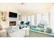 Bright living room with a fireplace, a blue couch and chairs, built-in shelves, and hardwood floors at 10 Marchmont Ct, Durham, NC 27705