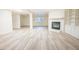 Spacious living room featuring luxury vinyl plank flooring, a fireplace, and custom built-in shelving at 10 Marchmont Ct, Durham, NC 27705
