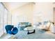 Vaulted ceiling living room with lots of windows, a fireplace, and modern decor at 10 Marchmont Ct, Durham, NC 27705