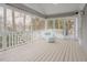Enclosed porch featuring painted wood flooring, white railings, and backyard views at 10 Marchmont Ct, Durham, NC 27705