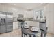 White kitchen with stainless appliances, tile backsplash and a cozy breakfast nook at 10121 Mizner Ln, Raleigh, NC 27617