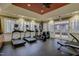 Well-equipped gym with treadmills and other exercise machines near windows and doors at 10321 Sablewood Dr # 113, Raleigh, NC 27617