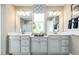 Elegant bathroom with double sinks, white cabinetry, quartz counters, and modern lighting at 1052 Country Pasture Cv, Wendell, NC 27591