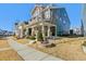 Two-story home with teal siding, a welcoming front porch, and landscaped yard, as seen from the sidewalk at 1132 Gloriosa St, Apex, NC 27523