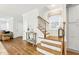 Inviting foyer with wooden staircase, hardwood floors, neutral walls, and stylish decorative accents at 1132 Gloriosa St, Apex, NC 27523