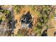 Overhead view of the property, featuring a circular driveway, firepit, and a detached storage shed at 1328 Wakefield Farm Rd, Zebulon, NC 27597