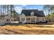 Beautiful backyard featuring a spacious lawn and neutral colored home with covered porch at 1328 Wakefield Farm Rd, Zebulon, NC 27597