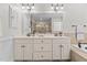 Bathroom featuring a double vanity with framed mirror, a large soaking tub and tiled shower at 1328 Wakefield Farm Rd, Zebulon, NC 27597