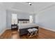 Comfortable bedroom featuring a tray ceiling, hardwood floors, and two bedside tables at 1328 Wakefield Farm Rd, Zebulon, NC 27597