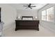 Spacious bedroom with a dark wood sleigh bed and plush carpeting at 1328 Wakefield Farm Rd, Zebulon, NC 27597