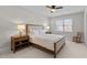 Bright bedroom with a queen-size bed, neutral colors, and natural light at 1328 Wakefield Farm Rd, Zebulon, NC 27597