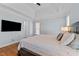 This bedroom features a comfortable king-size bed with a wall mounted TV at 1328 Wakefield Farm Rd, Zebulon, NC 27597