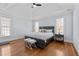 Spacious bedroom boasts hardwood floors, tray ceiling, and plenty of natural light at 1328 Wakefield Farm Rd, Zebulon, NC 27597