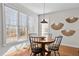 Bright breakfast nook with round table, four chairs, and large windows providing natural light at 1328 Wakefield Farm Rd, Zebulon, NC 27597
