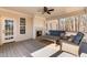 Elegant covered porch featuring a cozy outdoor seating area and a fireplace at 1328 Wakefield Farm Rd, Zebulon, NC 27597