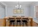 Elegant dining room features modern chandelier, light wood table, and beautiful wall decor at 1328 Wakefield Farm Rd, Zebulon, NC 27597