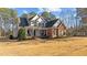 Elegant two-story house showcasing a spacious front yard with mature trees at 1328 Wakefield Farm Rd, Zebulon, NC 27597