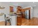 Charming kitchen with stainless steel refrigerator and dark wood cabinets and bar at 1328 Wakefield Farm Rd, Zebulon, NC 27597