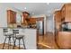 Fully equipped kitchen features bar seating, stainless steel appliances, and dark wood cabinets at 1328 Wakefield Farm Rd, Zebulon, NC 27597