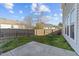 View of the backyard with partial green grass and fence at 1510 Roaring Rapids Rd, Raleigh, NC 27610