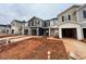 New townhome construction showing attached garages and exteriors that are under construction at 154 Parker Ln, Mebane, NC 27302