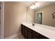 Bathroom featuring a dark vanity, large mirror, and neutral walls, creating a functional space at 1546 Tinos Overlook Way, Apex, NC 27502