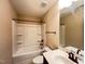 Bathroom featuring a tub/shower combo and dark fixtures, creating a functional and accessible space at 1546 Tinos Overlook Way, Apex, NC 27502
