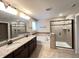 Elegant bathroom with double vanity, soaking tub, and separate tiled shower with glass door at 1546 Tinos Overlook Way, Apex, NC 27502