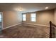 A cozy bedroom featuring plush carpet, two bright windows, and neutral paint at 1546 Tinos Overlook Way, Apex, NC 27502