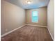 Cozy bedroom with neutral paint, carpet flooring, natural light, and electrical outlets at 1546 Tinos Overlook Way, Apex, NC 27502