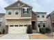 Charming two-story home featuring mixed siding, stone accents, attached garage, and inviting entrance at 1546 Tinos Overlook Way, Apex, NC 27502