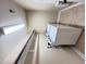 A clean and functional laundry room with modern appliances and ample shelving for storage at 1546 Tinos Overlook Way, Apex, NC 27502