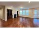 Inviting living room featuring hardwood floors, built-in bookshelves, fireplace, and natural light at 1546 Tinos Overlook Way, Apex, NC 27502