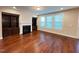 Inviting living room featuring hardwood floors, built-in bookshelves, fireplace, and natural light at 1546 Tinos Overlook Way, Apex, NC 27502