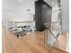 Elegant foyer with wood and glass stair railing and chandelier hanging above a view of the dining room at 1616 Hunting Ridge Rd, Raleigh, NC 27615