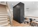 Bright foyer staircase with hardwood stairs, glass railing, and decorative black and gold accent wall at 1616 Hunting Ridge Rd, Raleigh, NC 27615