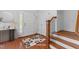 Bright foyer with wood floors, white walls, and a staircase with wooden handrail at 200 Valleyshire Rd, Durham, NC 27707