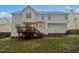 The backyard features a deck, stairs, and a view of the home's exterior at 206 Collegiate Cir, Durham, NC 27713