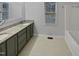 A bathroom with a double vanity, granite counters, and a shower/tub combo at 206 Collegiate Cir, Durham, NC 27713