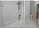 A clean bathroom with white tiled shower/tub and white toilet at 206 Collegiate Cir, Durham, NC 27713