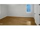 This bedroom features hardwood floors and a window letting in plenty of natural light at 206 Collegiate Cir, Durham, NC 27713