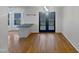 Dining area with hardwood floors and a modern light fixture, complemented by natural light from the windows at 206 Collegiate Cir, Durham, NC 27713