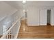 A hallway on the second floor with hardwood floors and white railings at 206 Collegiate Cir, Durham, NC 27713