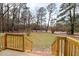 A verdant backyard, captured from the wooden porch, merges seamlessly with the natural wooded landscape at 2116 Nc Highway 751, Apex, NC 27523