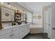 Bright bathroom features double sinks, white cabinets, and corner tub at 226 Fletcher Ridge Rd, Timberlake, NC 27583