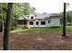 The back of the home has a large yard and screened-in porch at 2410 Carpenter Pond Rd, Raleigh, NC 27613