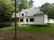 The backyard has a screened-in porch and nice landscaping at 2410 Carpenter Pond Rd, Raleigh, NC 27613